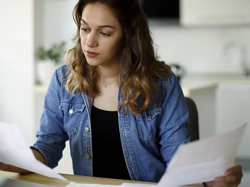 young woman looking at paperwork
